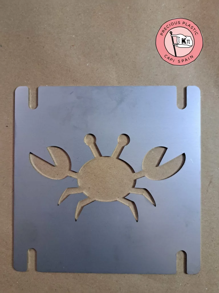 Stainless‑steel injection mould plate featuring one Crab silhouette, part of the Marine World Collection by Precious Plastic Capi Spain.