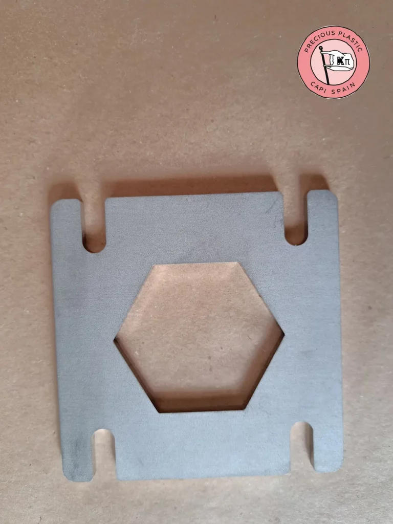 Stainless steel mini injection mould plate with a hexagon shape, from Precious Plastic Capi Spain's Mini Injection Moulds Series.