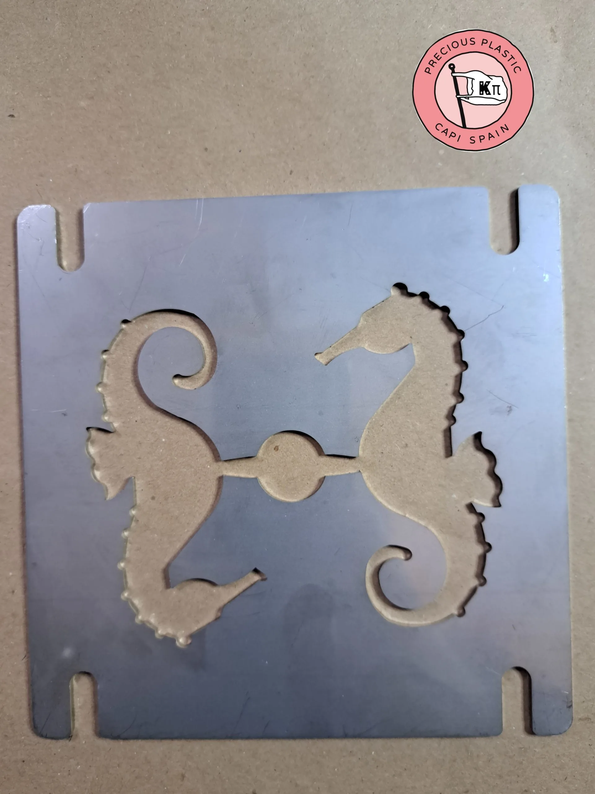 Stainless‑steel injection mould plate featuring two seahorse silhouettes, part of the Marine World Collection by Precious Plastic Capi Spain.