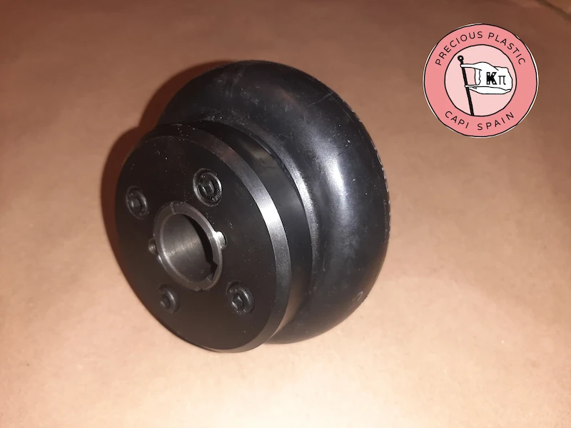 Perspective view of a flexible rubber coupling with keyway and fastening screws for a shredder motor shaft.
