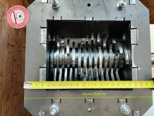Measuring the 22 cm external hopper width of the assembled Precious Plastic V3.3 shredder box using a tape measure.