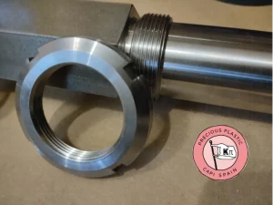 KM7 slotted locknut made of ground steel next to the threaded section of the V3.3 shredder shaft.